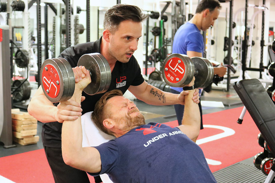  Nick-in-the-gym-with-trainer-dumbbells Ultimate Performance