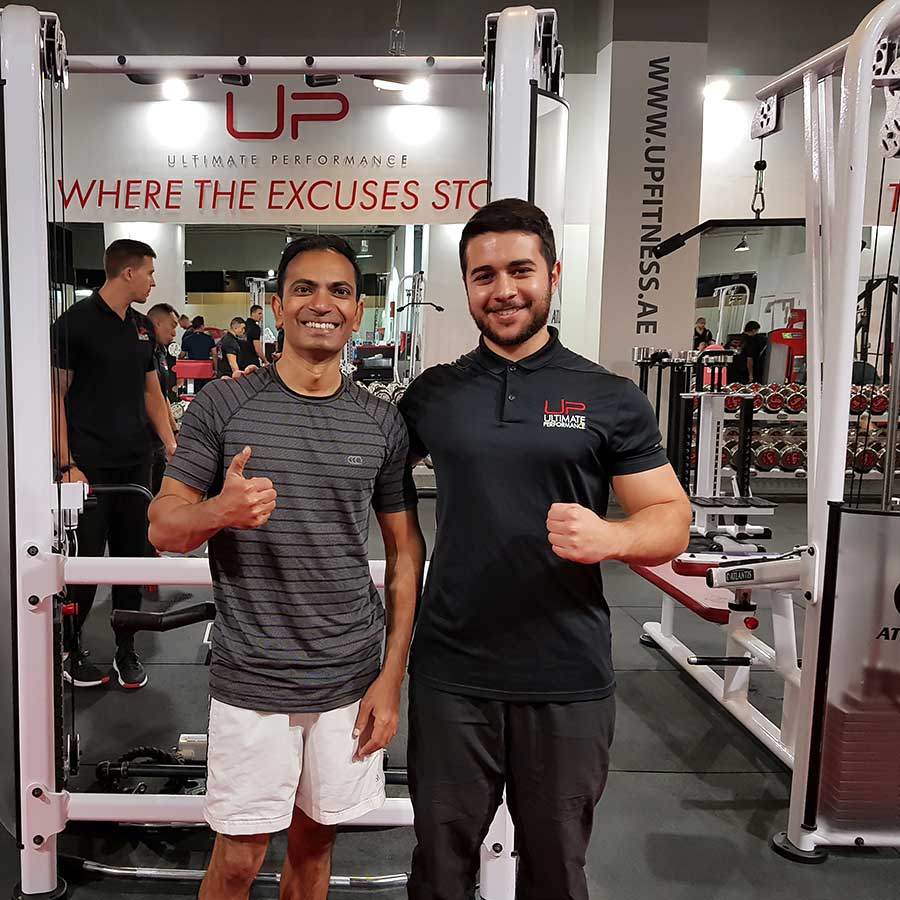  Aasif-in-gym-smiling-with-trainer Ultimate Performance